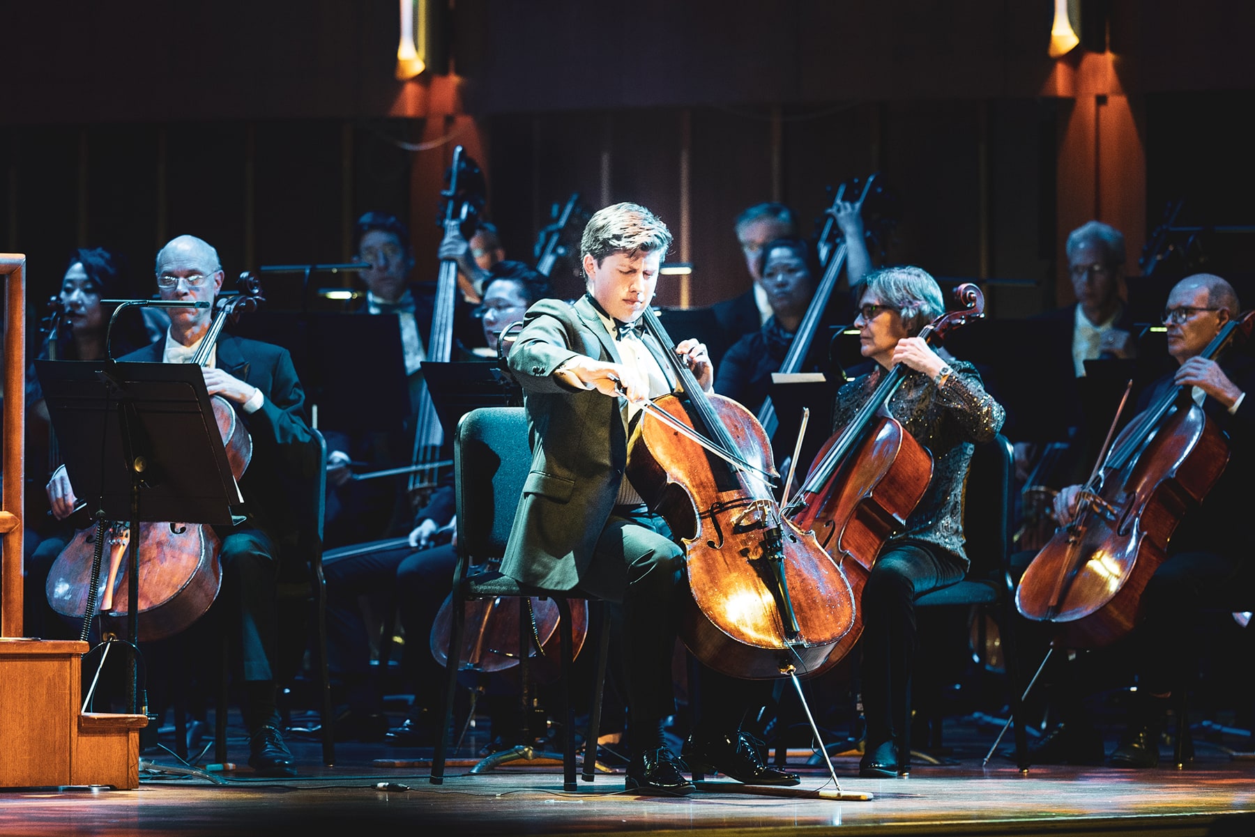 Man playing a cello solo on stage