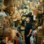 Jun standing, surrounded by baskets